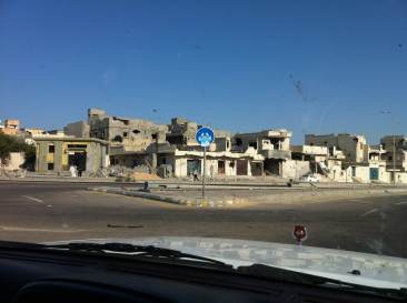 a devastated street in Libya after NATO bombing how did that protect innocent civilians?